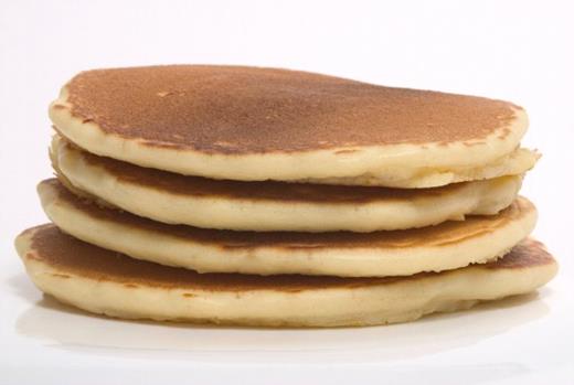 An electron micrograph of a Golgi stack (top). A stack of pancakes (bottom) depicts the unusual structure of the Golgi, which has fascinated Malhotra for two decades.